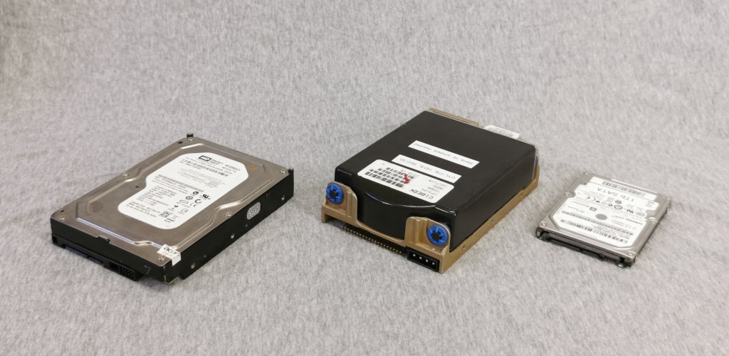Physical size comparison of a Conner CPCP3104 hard drive to a modern quarter height 3.5" and 2.5" laptop hard drive
