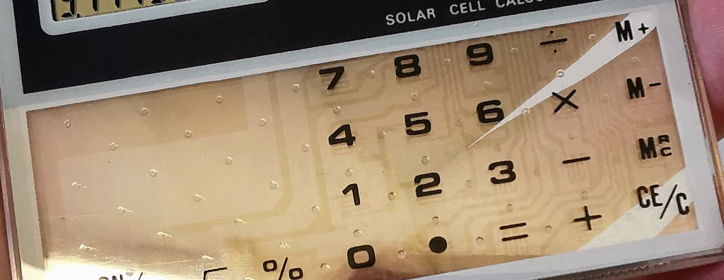Close up with contrast enhanced to show keypad circuitry detail on the generic transparent calculator