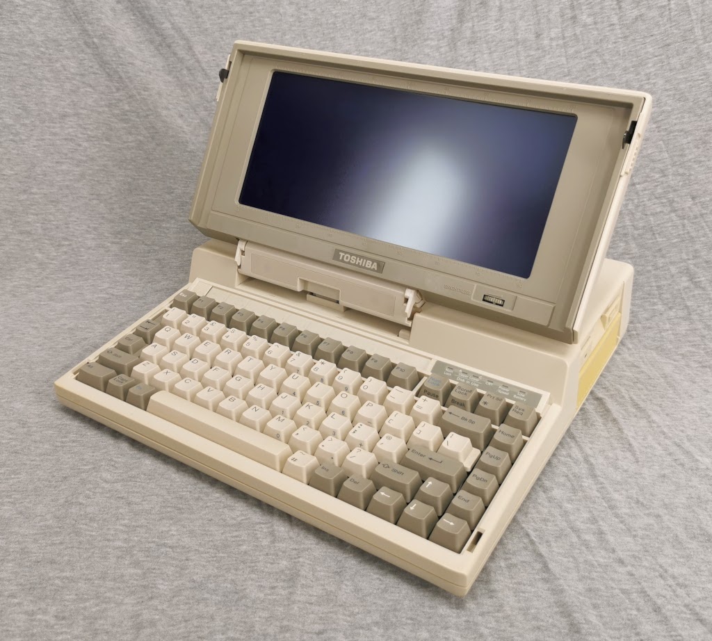 General overview of a Toshiba T1200 from the front right with the display open